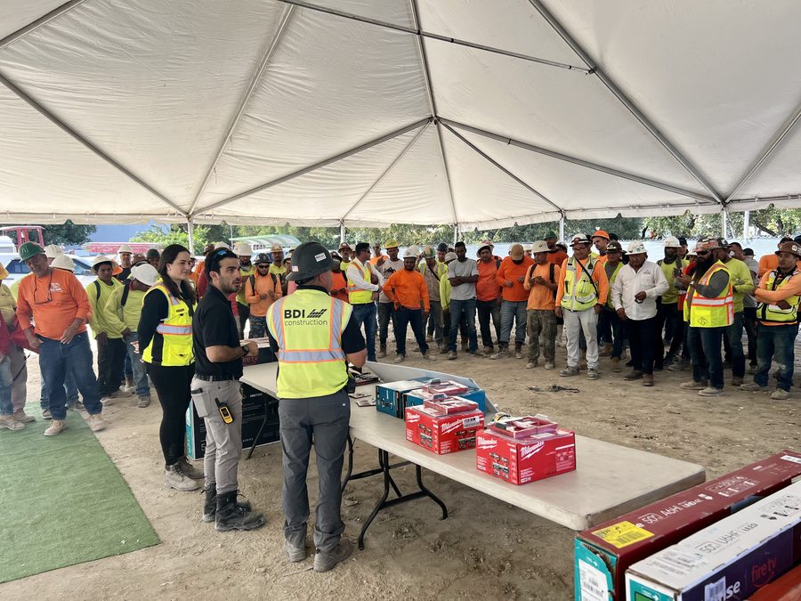 Trade crews gathered under a tent at a BDI Construction jobsite appreciation event