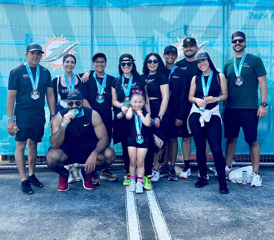 BDI Construction staff with their medals at the Dolphins Cancer Challenge