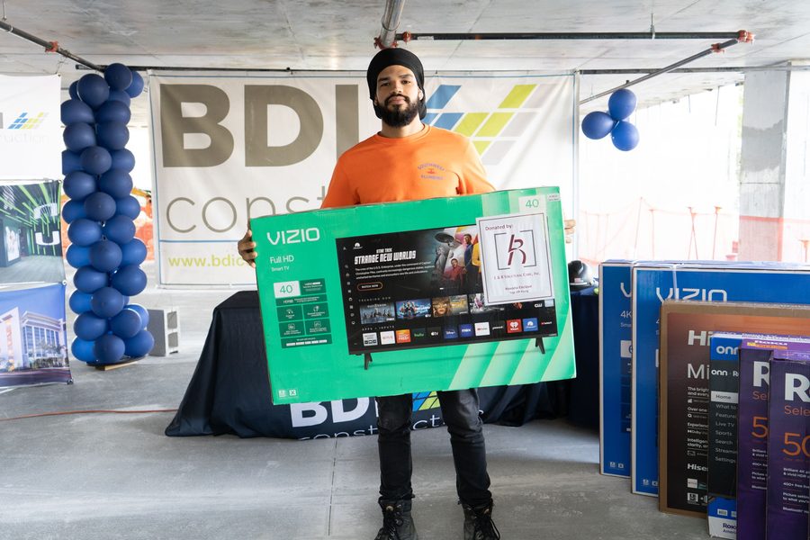 A tradesman with the television he won at a BDI Construction crew appreciation event
