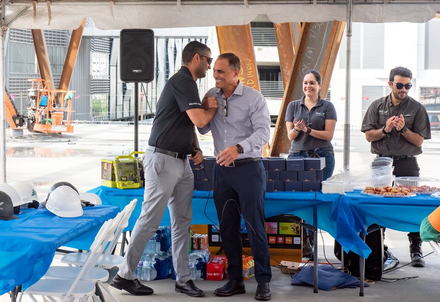 Colleagues greeting one another at a BDI Construction topping out celebration